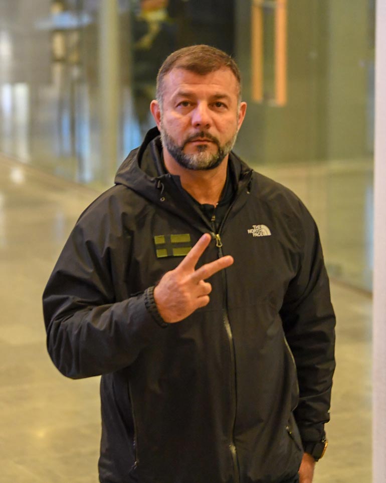 Rami näytti käänteistä voitonmerkkiä. Merkillä on monta tulkintaa, mutta usein elettä verrataan keskisormen näyttämiseen.