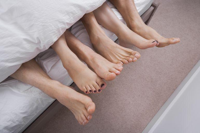 Moniavioinen kolmikko jakaa sängyn.